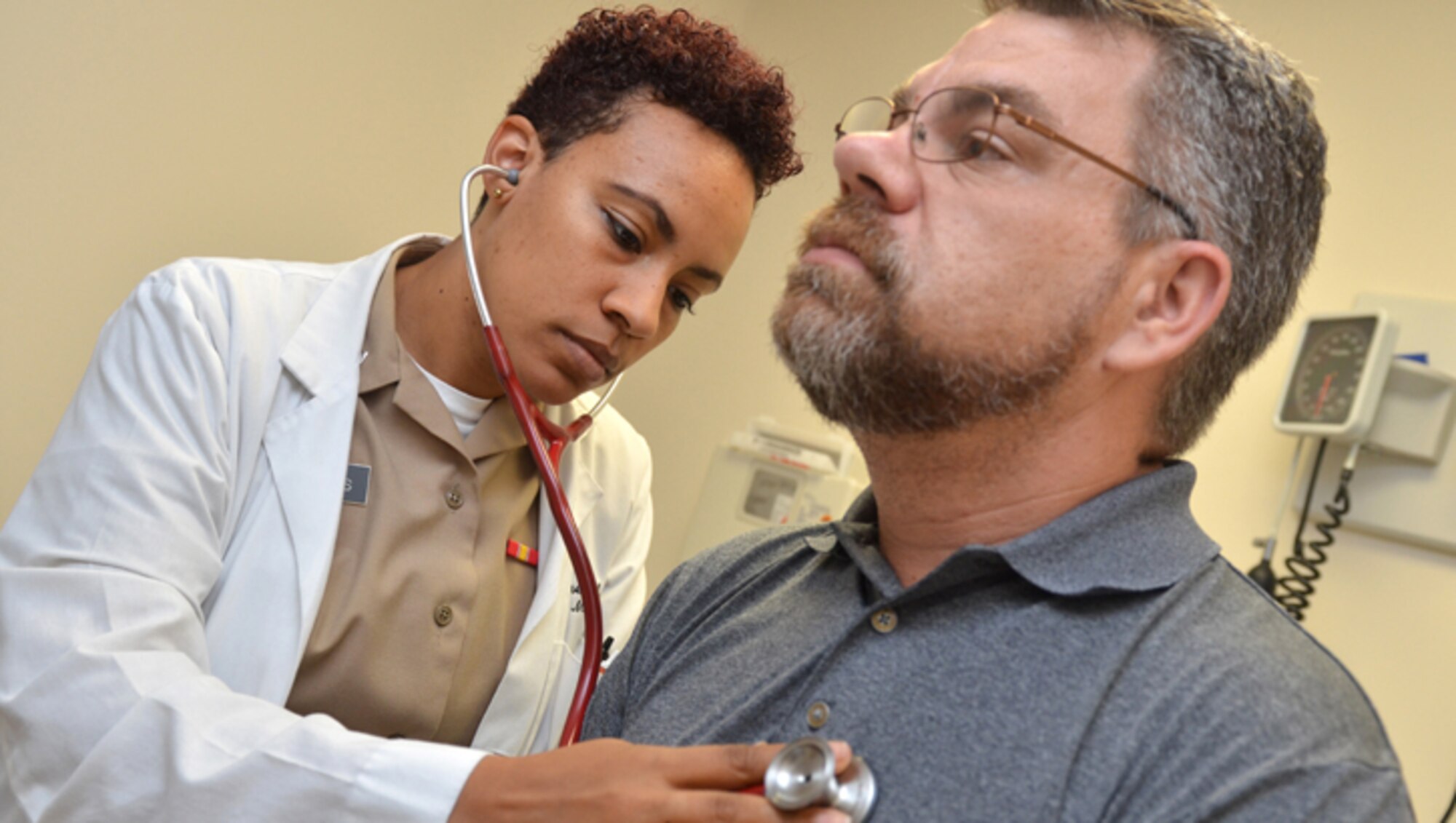 JACKSONVILLE, Fla. (June 19, 2019) – Lt. Taylor James, a physician at Naval Hospital Jacksonville’s Family Medicine Clinic, checks retired Navy Chief Mike Misiak’s heart.  James, a native of Toledo, Ohio, earned her Doctor of Medicine at The Commonwealth Medical College.  She’s completing her family medicine residency on June 30.  “It’s been a challenging and rewarding experience here at the hospital.  I’m going to miss my patients and I hope that I’ve made a positive impact on your lives.  I’m a partner in your care, together, keeping you healthy.”  (U.S. Navy photo by Jacob Sippel, Naval Hospital Jacksonville/Released).