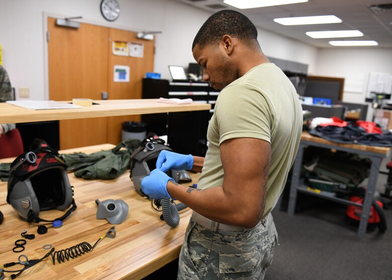 Airman 1st Class Joshua Chatman, 9th Operations Support Squadron aircrew flight equipment specialist, places a strain relief cord back into an oxygen mask hose after cleaning it out, Jan. 22, 2020 at Beale Air Force Base, California. To ensure oxygen masks are properly functioning, aircrew flight equipment specialists inspect them every 30 days. (U.S. Air Force photo by Airman 1st Class Luis A. Ruiz-Vazquez)