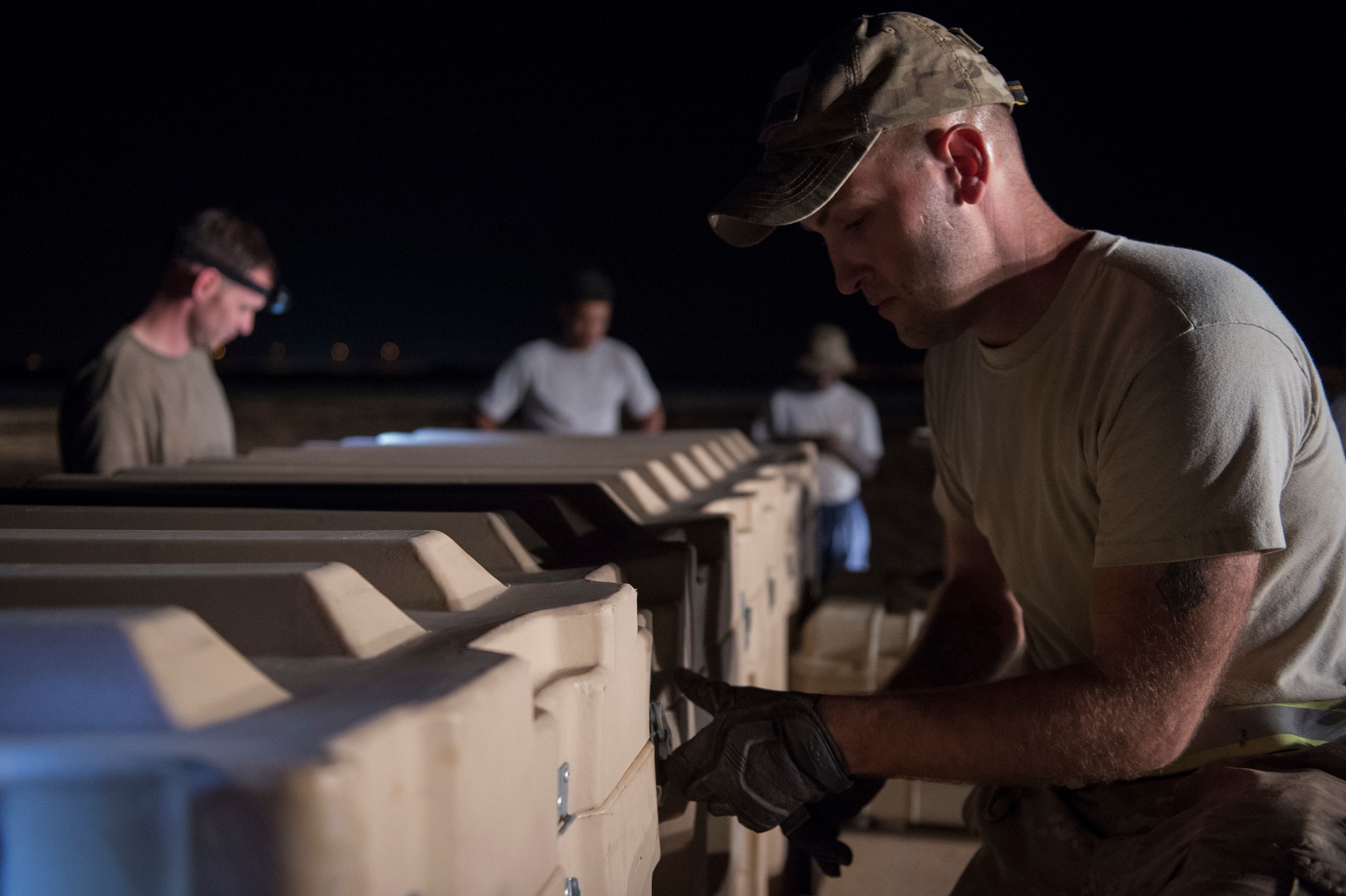 Airmen from the 621st Contingency Response Group pack supplies onto a pallet in preparation to redeploy at Prince Sultan Air Base, Kingdom of Saudi Arabia, July 27, 2019. Most construction and deconstruction operations take place at night to avoid heat-related complications. The 621st CRG deployed for an air base opening mission in response to the White House authorization of approximately 1,000 additional troops in U.S. Central Command's area of responsibility for defensive purposes to address air, naval, and ground-based threats in the Middle East. (U.S. Air Force photo by Staff Sgt. Sarah Brice)