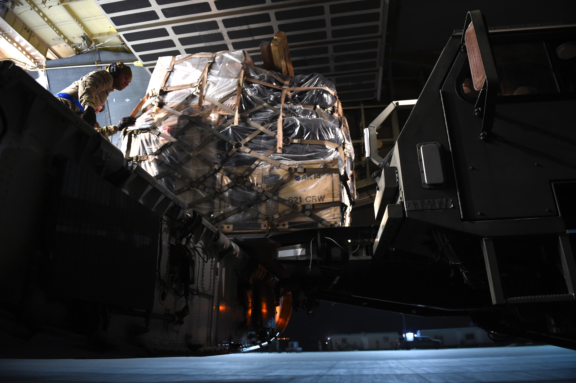 Airmen from the 621st Contingency Response Group help offload equipment from a C-5M Super Galaxy at Prince Sultan Air Base, Kingdom of Saudi Arabia, June 26, 2019. The 621st CRG deployed for an air base opening mission in response to the White House authorization of approximately 1,000 additional troops in U.S. Central Command's area of responsibility for defensive purposes to address air, naval, and ground-based threats in the Middle East. (U.S. Air Force photo by Staff Sgt. Sarah Brice)