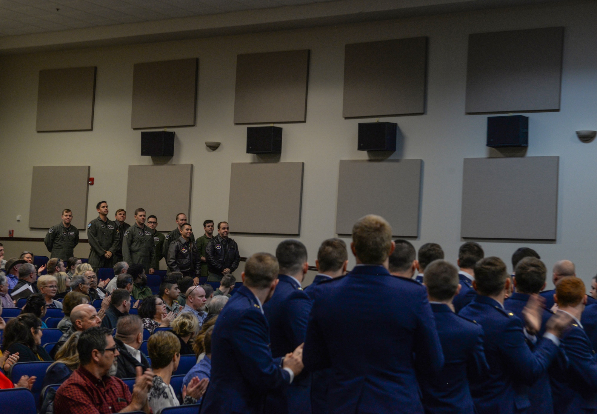 Graduates from Specialized Undergraduate Pilot Training Class 20-06/07 clap, showing appreciation for 14th Flying Training Wing instructor pilots, Jan. 27, 2020, at Columbus Air Force Base, Mississippi. Upon graduating from SUPT, graduates receive their “silver wings” and gain the title of “pilot”. (U.S. Air Force photo by Airman Davis Donaldson)