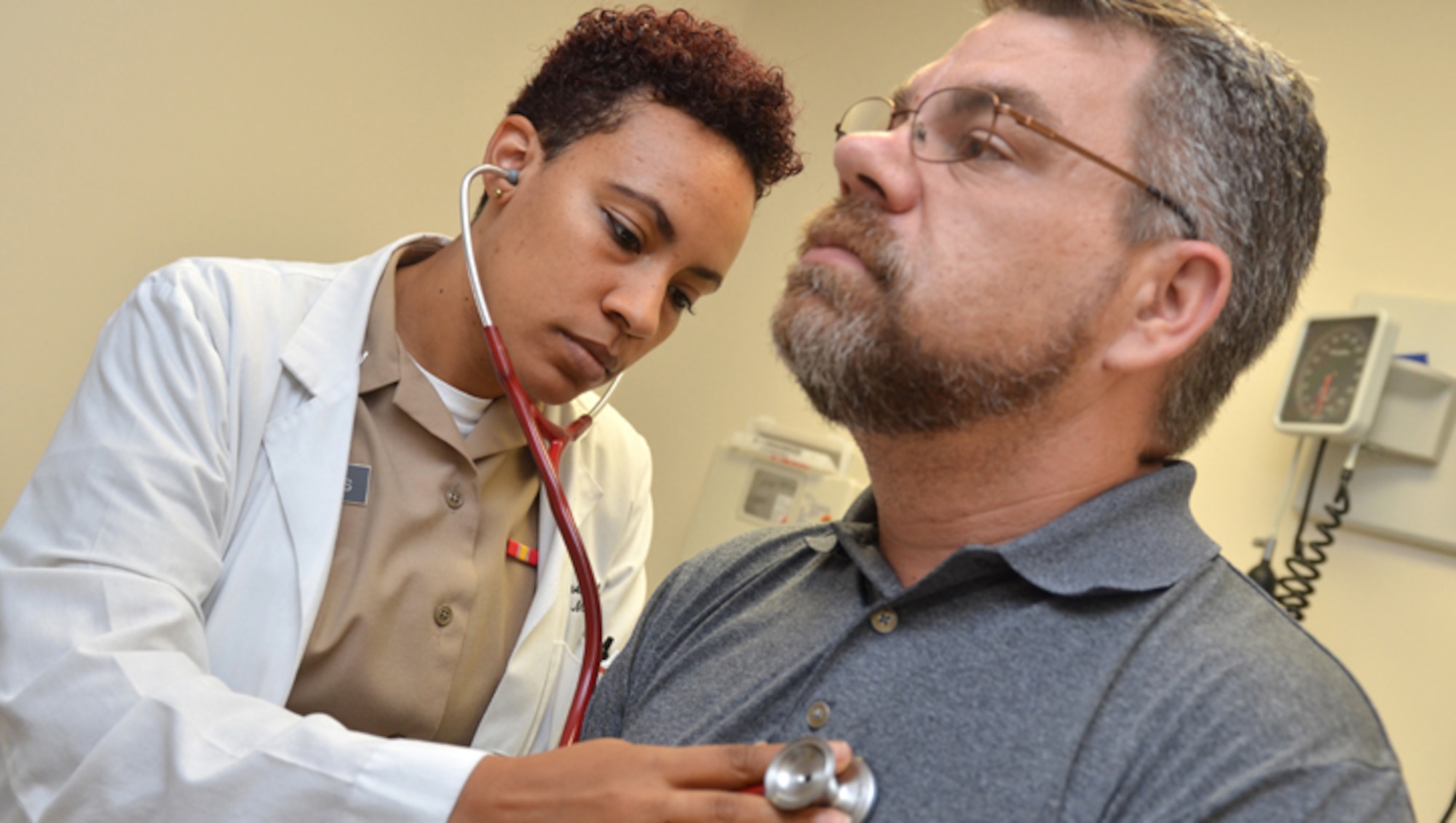 JACKSONVILLE, Fla. (June 19, 2019) – Lt. Taylor James, a physician at Naval Hospital Jacksonville’s Family Medicine Clinic, checks retired Navy Chief Mike Misiak’s heart.  James, a native of Toledo, Ohio, earned her Doctor of Medicine at The Commonwealth Medical College.  She’s completing her family medicine residency on June 30.  “It’s been a challenging and rewarding experience here at the hospital.  I’m going to miss my patients and I hope that I’ve made a positive impact on your lives.  I’m a partner in your care, together, keeping you healthy.”  (U.S. Navy photo by Jacob Sippel, Naval Hospital Jacksonville/Released).