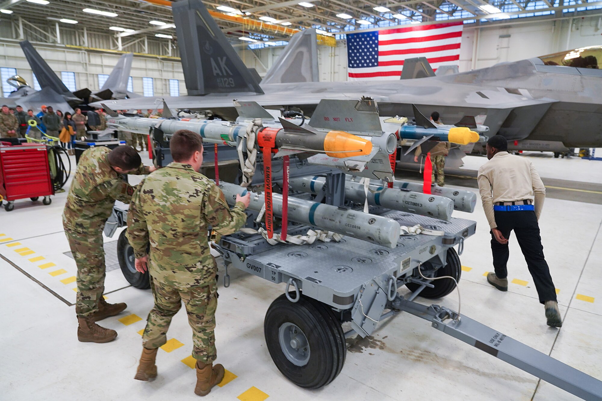Airmen assigned to the 90th and 525th Aircraft Maintenance Units compete during a timed F-22 Raptor load crew competition on Joint Base Elmendorf-Richardson, Alaska, Jan. 31, 2020.