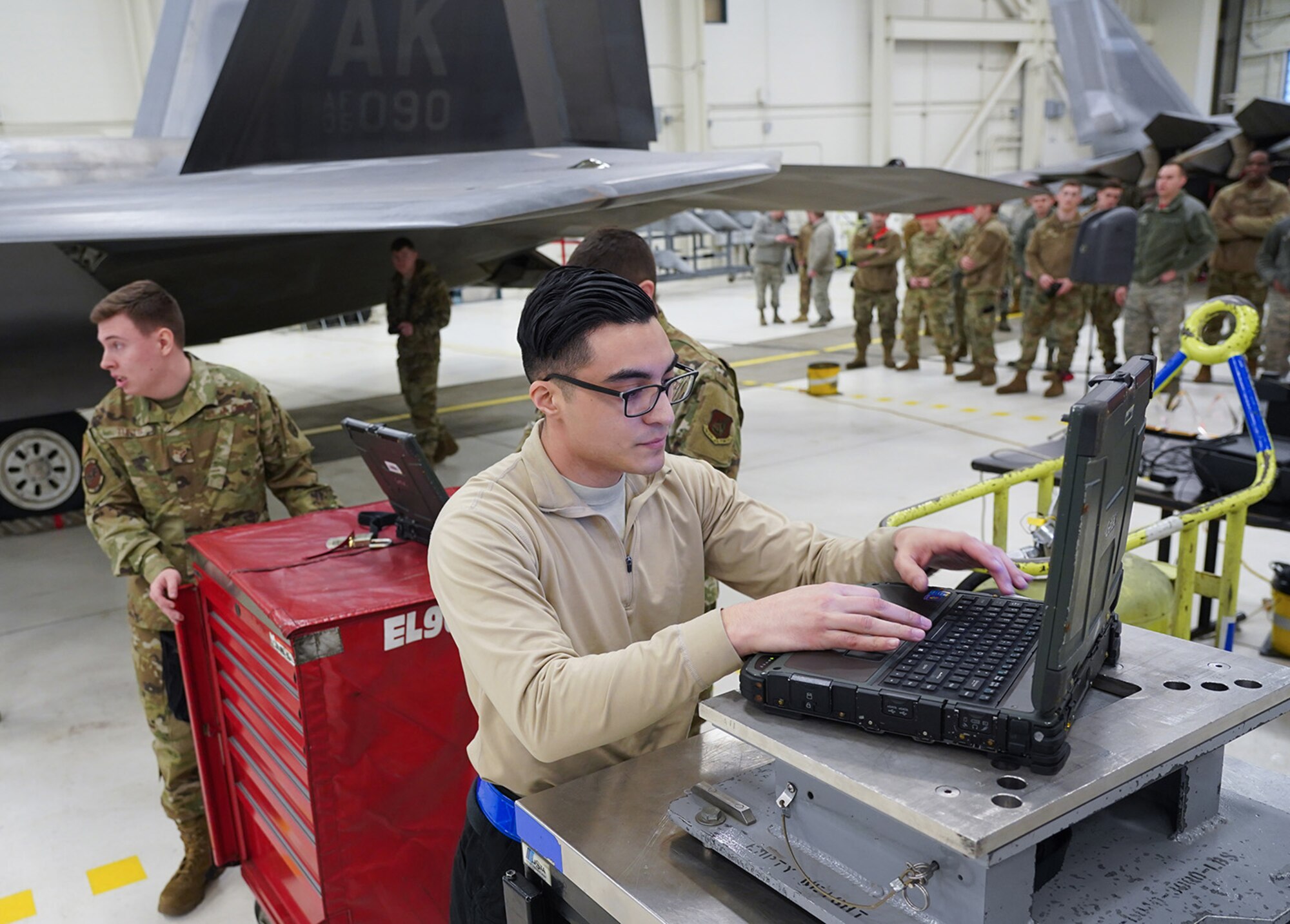 Airmen assigned to the 90th and 525th Aircraft Maintenance Units compete during a timed F-22 Raptor load crew competition on Joint Base Elmendorf-Richardson, Alaska, Jan. 31, 2020.
