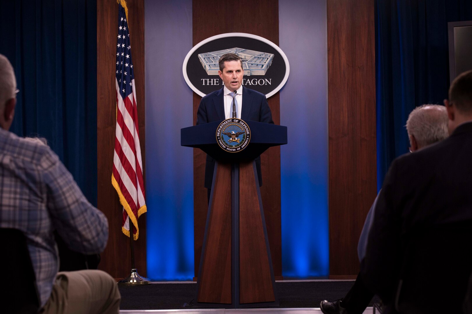 A man speaks from a podium.