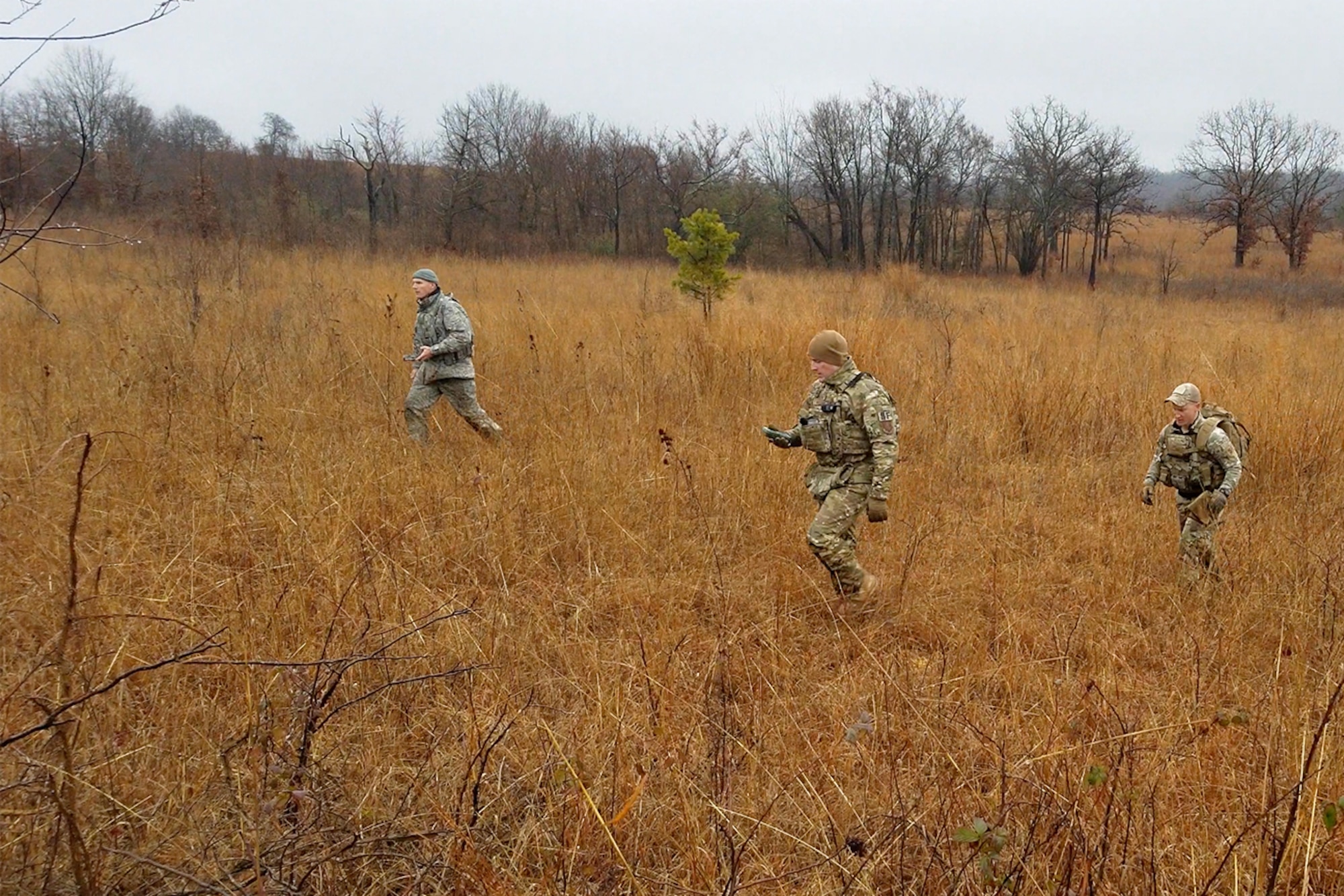 Senior Master Sgt. Bradley Rose, 185th Security Forces Squadron (from left), Master Sgt. Gregory Wardle, 153rd SFS, and Staff Sgt. Jonathan Finer, 124th SFS, tackle a land navigation course Jan. 23, 2020, at Ft. Chaffee, Arkansas. The team of Airmen from across the Air National Guard gathered to train for the Air Force Defender Challenge, a security forces skills competition. (U.S. Air National Guard photo by Master Sgt. Chauncey Reed)