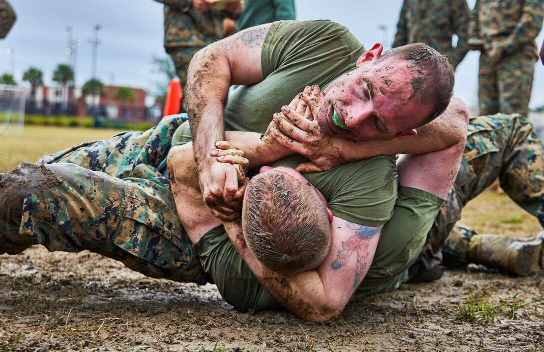 A U.S. Marine with Marine Forces Reserve takes down his opponent during a grappling match for the King of the Ring tournament at Marine Corps Support Facility New Orleans, Jan. 31, 2020. The tournament challenges competitors to three categories of knife fighting, grappling and baton fighting to become the overall King of the Ring champion. (U.S. Marine Corps photo by Lance Cpl. Leslie Alcaraz)