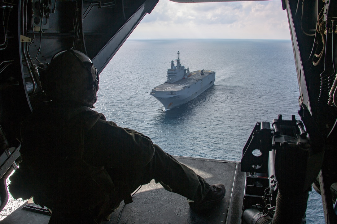 A U.S. Marine observes the French amphibious assault ship Dixmude in the Atlantic Ocean, Jan. 6.