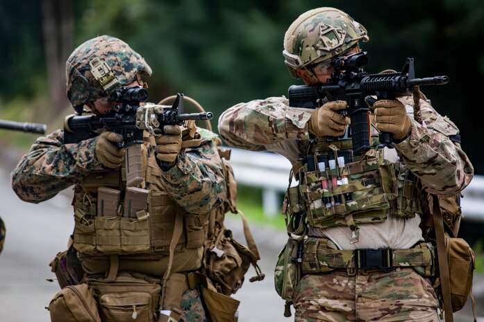 A U.S. Marine and U.S. Airman inspect a bridge containing Unexploded Explosive Ordnance during an operational area clearance scenario during EOD Field Exercise 20.1 at the Central Training Area, Camp Hansen, Okinawa, Japan, Jan. 15.