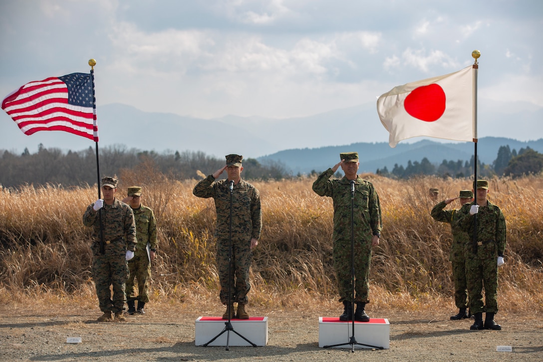U.S. Marines and Japan Ground Self-Defense Force Col. Kouki Watanabe, salute the formations of U.S. Marines and Japan Ground Self-Defense Force Service Membersduring the opening ceremony for Exercise Forest Light Western Army at Camp Oyanohara, Kyushu, Japan, Jan. 18.