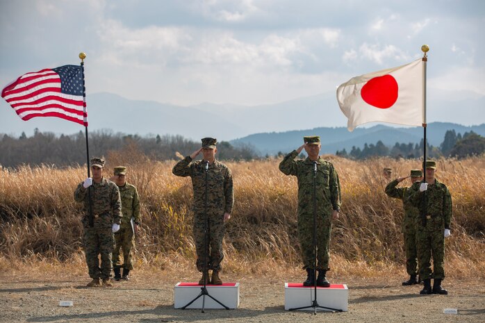 U.S. Marines and Japan Ground Self-Defense Force Col. Kouki Watanabe, salute the formations of U.S. Marines and Japan Ground Self-Defense Force Service Membersduring the opening ceremony for Exercise Forest Light Western Army at Camp Oyanohara, Kyushu, Japan, Jan. 18.