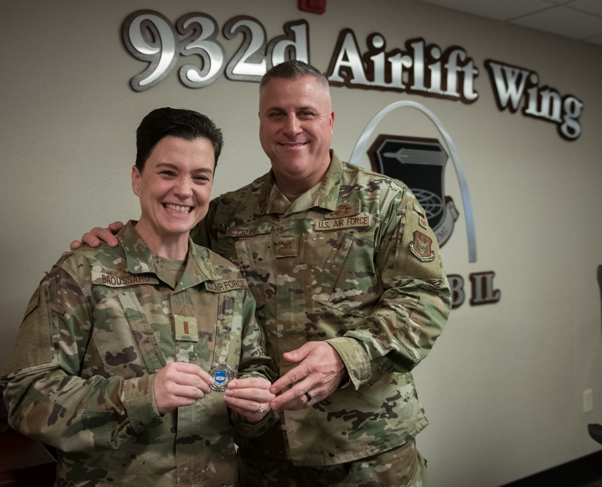 Col. Michael Cruff, vice commander, 932nd Airlift Wing, poses with 2nd Lt. Melissa Broussard, force support officer, Force Support Squadron, with Wing coin in hand, following Broussard having shared her Air Force story with Wing leadership, Jan. 10, 2020, Scott Air Force Base, Illinois.  (U.S. Air Force photo by Christopher Parr)