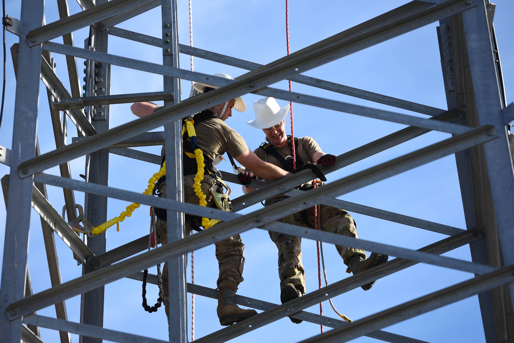 Chief Master Sgt. Kellie Brisse (right), 14th Operations Group superintendent, and Senior Airman Brandon Culp, 14th Operations Support Squadron’s Radar, Airfield and Weather Systems journeyman,  climbs a radio tower at the Ground-To-Air Transmitter and Receiver Site Jan. 28, 2020, on Columbus Air Force Base Mississippi. The RAWS flight provides around-the-clock support of base and regional radar equipment, ground-to-air radios and weather systems that support air traffic control, the National Weather Service, and command and control across the wing. (U.S. Air Force photo by Airman 1st Class Jake Jacobsen)