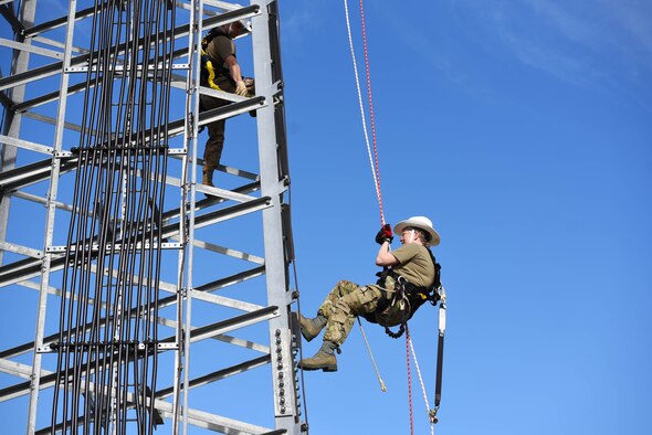 Chief Master Sgt. Kellie Brisse (right), 14th Operations Group superintendent, propels down a radio tower supervised by Senior Airman Brandon Culp, 14th Operations Support Squadron’s Radar, Airfield and Weather Systems journeyman, at the Ground-To-Air Transmitter and Receiver Site Jan. 28, 2020, on Columbus Air Force Base Mississippi. Training is implemented to help Airmen become familiar and comfortable with the equipment they use, and create safe work habits. (U.S. Air Force photo by Airman 1st Class Jake Jacobsen)