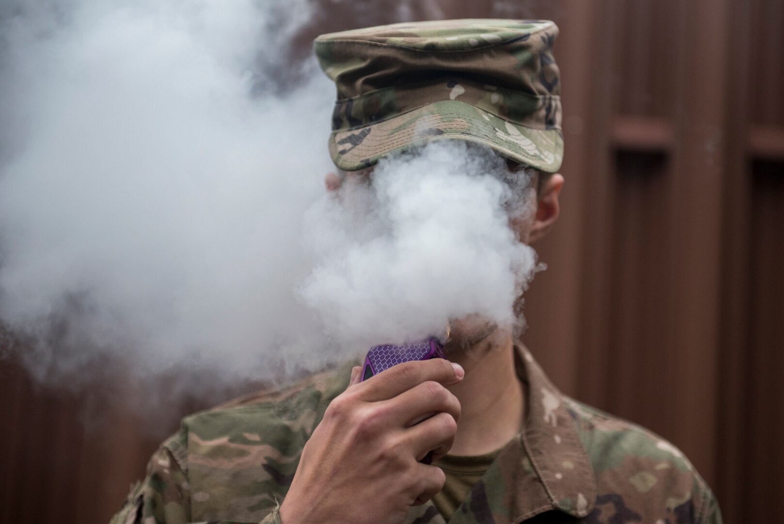 An Airman vapes in an authorized smoking area during a break. As of Oct. 29, 2019, more than 1,800 lung injury cases and 37 deaths have been reported to the Centers for Disease Control and Prevention with the only commonality among all cases being the patient’s use of e-cigarettes or vaping products.