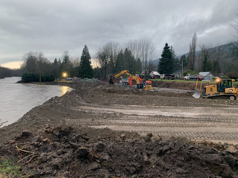 U.S. Army Corps of Engineers contractors, using bulldozers and excavators flood fight along the Skagit River near the City of Lyman, Washington, February 1. Seattle District water managers took control of the Upper Baker and Ross dams upstream of Lyman per established agreements February 1. Corps officials held back about 19,000 cubic feet per second, or cfs, at both dams, reducing downstream Skagit River flows at Concrete, Washington, from about 114,000 cfs to 78,000 cfs. This is equivalent to a river stage reduction of more than five feet.
