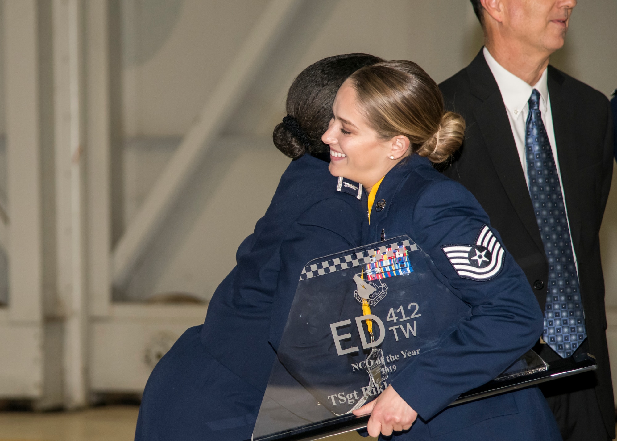 Tech. Sgt. Rikki Glowacki, the Noncomissioned Officer of the Year winner, is congratulated by her group commander, Col. Gwendolyn Foster, 412th Medical Group Commander, during the 412th Test Wing's Annual Awards Banquet, at Edwards Air Force Base, California, Jan. 31. (Air Force photo by Giancarlo Casem)