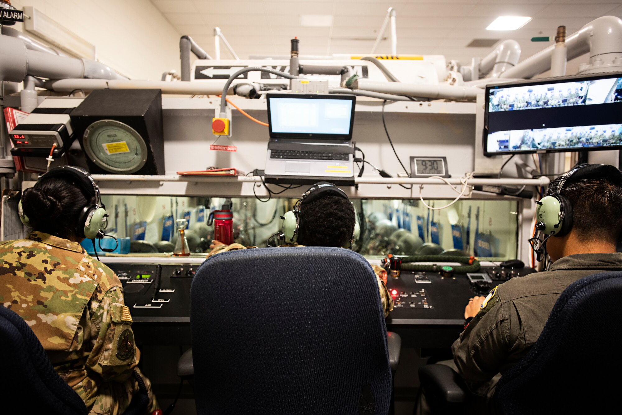 Tech. Sgt. Miriam Hernandez, Senior Airman Deaja Ellis and Senior Airman Duver Navarro Narvaez, 359th Aerospace Medicine Squadron aerospace and operational physiology technicians, monitor and quiz students in a hypobaric chamber Jan. 28, 2020 at Joint Base San Antonio-Randolph, Texas.  Aerospace and operational physiology technicians help students mitigate mission and self-imposed stressors, such as diet and exercise habits, sleeping patterns, medications and smoking, and teach them how those factors can impact their performance. (U.S. Air Force photo by Tech. Sgt. Katherine Spessa)