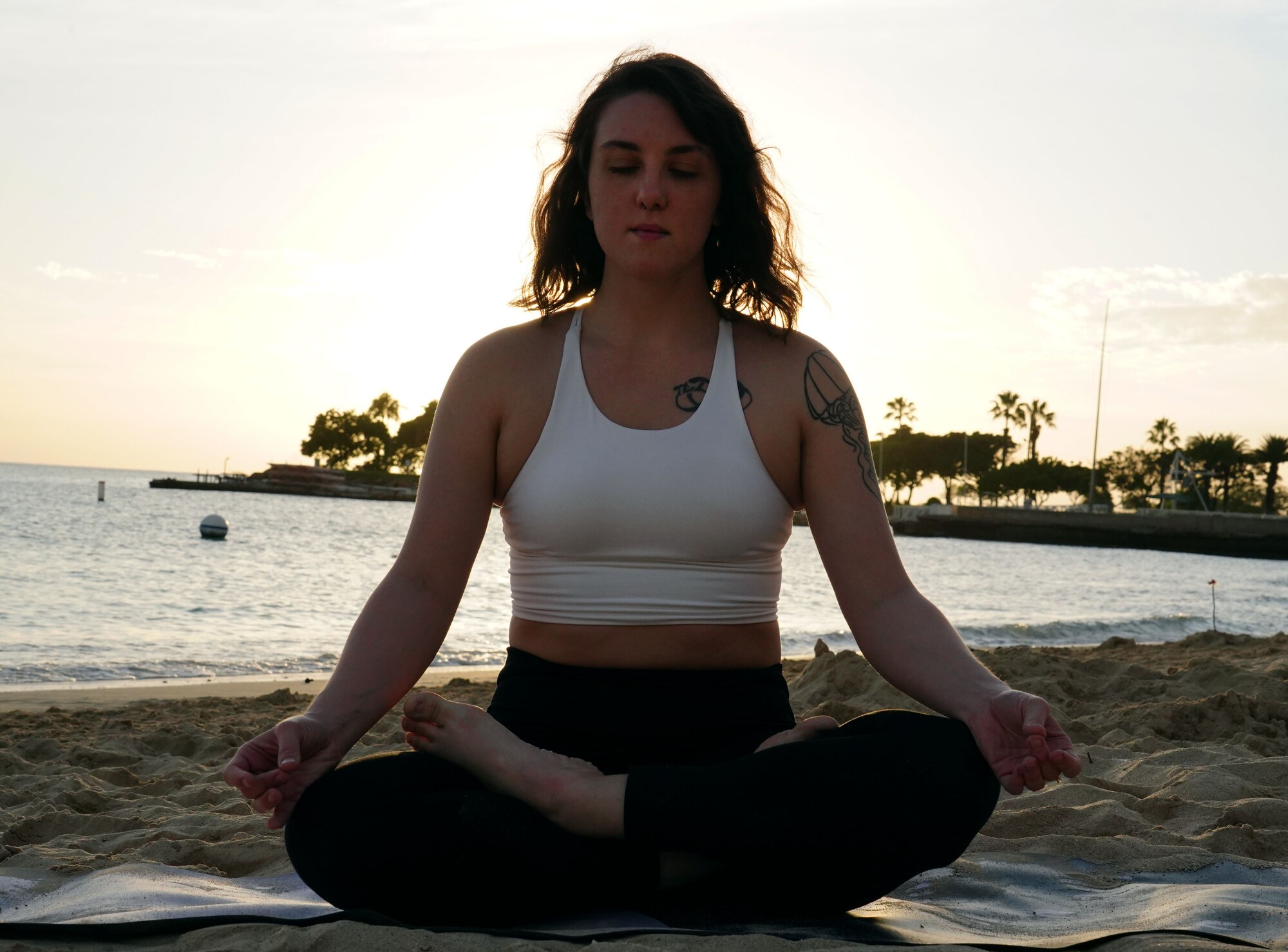 Jayme Ratcliff, 324th Intelligence Squadron Fusion Analyst, practices yoga on Hickam Beach on Joint Base Pearl Harbor-Hickam, Hawaii, Jan. 31, 2020. Yoga and meditation can be practiced conjunctively, each providing their own benefits, such as flexibility, strengthening, and a better night's sleep. (U.S. Air Force photo by Airman 1st Class Erin Baxter)