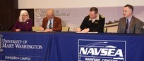 IMAGE: KING GEORGE, Va. (Jan. 31, 2020) – Dr. Troy Paino, University of Mary Washington president, and Capt. Casey Plew, NSWCDD commanding officer, sign a Memorandum of Understanding (MOU) at a ceremony held at the UMW Dahlgren campus, Jan. 31. Looking on are Dr. Nina Mikhalevsky, the university’s provost, and Darren Barnes, NSWCDD acting technical director, who were also MOU signatories. The MOU enables NSWCDD employees who qualify for the program to earn a project management certificate while applying the credits towards a Master of Business Administration. “We are delighted about this opportunity and hold it up as a shining example of the partnerships we are pursuing,” said Barnes. “It would not be possible without the University of Mary Washington.” (U.S. Navy photo/Released)