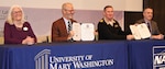 IMAGE: KING GEORGE, Va. (Jan. 31, 2020) – Dr. Troy Paino, University of Mary Washington president, and Capt. Casey Plew, NSWCDD commanding officer, hold the Memorandum of Understanding (MOU) they signed at a ceremony held at the UMW Dahlgren campus, Jan. 31. Looking on are Dr. Nina Mikhalevsky, the university’s provost, and Darren Barnes, NSWCDD acting technical director, who also signed the MOU which enables NSWCDD employees who qualify for the program to earn a project management certificate while applying the credits towards a Master of Business Administration. “We are excited at the University of Mary Washington about this partnership and program,” said Paino. “This program really aligns with our mission and vision moving forward. Partnerships matter and we’re here as a bridge to serve our community, our commonwealth, country, and the mission at Dahlgren.” (U.S. Navy photo/Released)