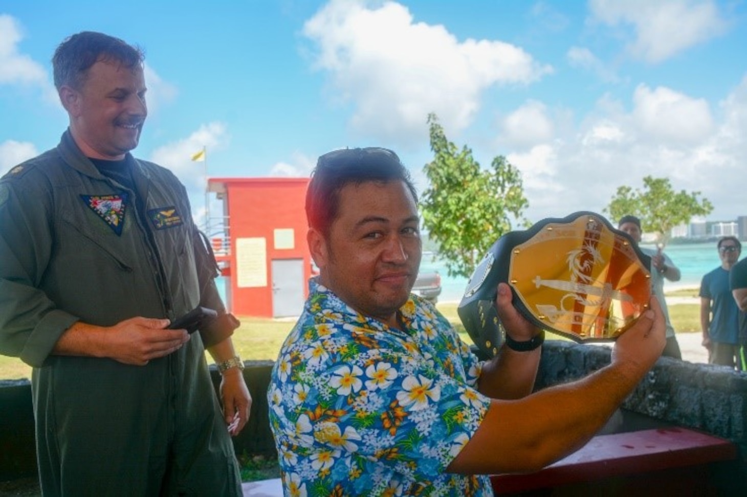 BEACH PARK, Guam (Jan. 27, 2020) - The officer in charge of the Royal New Zealand Navy team for Sea Dragon 2020 hoists the Anti-Submarine Warfare competition trophy, on behalf of his sailors. Sea Dragon is a multi-lateral anti-submarine warfare exercise that improves the interoperability elements required to effectively and cohesively respond to the defense of a regional contingency in the Indo- Pacific, while continuing to build and strengthen relationships held between nations.