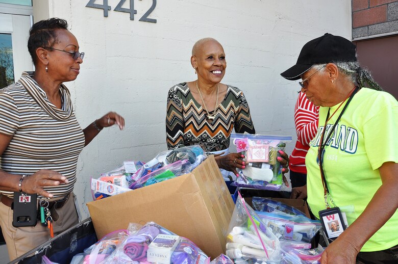 From left to right, Stephanie Hall, senior environmental protection specialist, Transportation and Special Projects Branch, U.S. Army Corps of Engineers Los Angeles District; Shirley Craig, donations and inventory associate at the Downtown Women’s Center, Los Angeles; and Pauline Williams, parking attendant at the women’s center, smile as they sort through plastic bags full of toiletry items donated Jan. 23 to the center by the U.S. Army Corps of Engineers Los Angeles District.