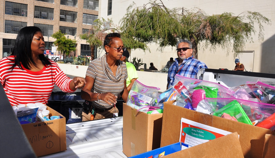 From left to right, Arnecia Williams, regional value officer, Engineering Division; Stephanie Hall, senior environmental protection specialist, Transportation and Special Projects Branch; and Gerry Salas, environmental engineer, all with the U.S. Army Corps of Engineers Los Angeles District, unload boxes of toiletries Jan. 23 at the Downtown Women’s Center, Los Angeles.