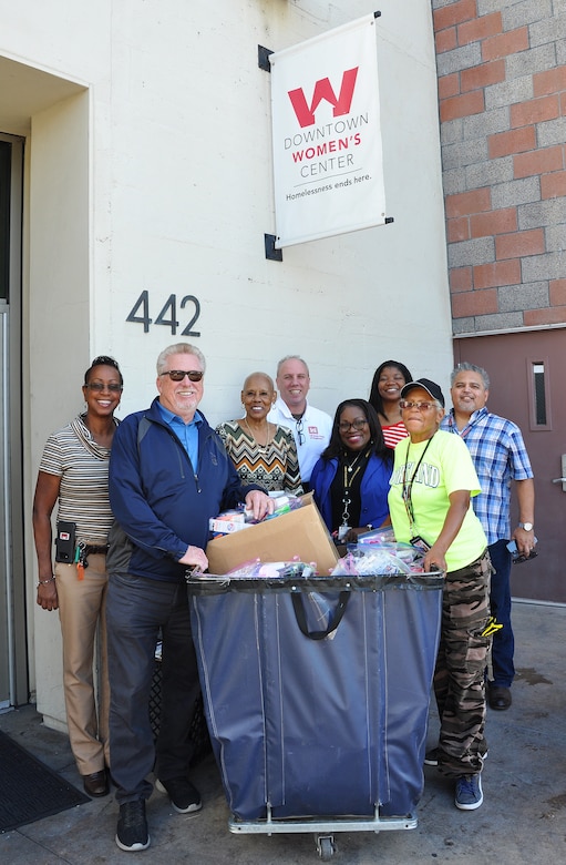 From left to right, Stephanie Hall, senior environmental protection specialist, Transportation and Special Projects Branch, U.S. Army Corps of Engineers Los Angeles District; Donald Lank, Equal Employment Opportunity manager, U.S. Army Corps of Engineers Los Angeles District; Shirley Craig, donations and inventory associate, Downtown Women’s Center, Los Angeles; Hollis Champlain, Equal Employment Opportunity specialist, U.S. Army Corps of Engineers Los Angeles District; Felicia Weaver, administrative assistant, Public Affairs, U.S. Army Corps of Engineers Los Angeles District; Arnecia Williams, regional value officer, Engineering Division, U.S. Army Corps of Engineers Los Angeles District; Pauline Williams, parking attendant at the women’s center; and Gerry Salas, environmental engineer, U.S. Army Corps of Engineers Los Angeles District, pose for a picture Jan. 23 in front of a cart full of toiletries donated to the center by the Corps.