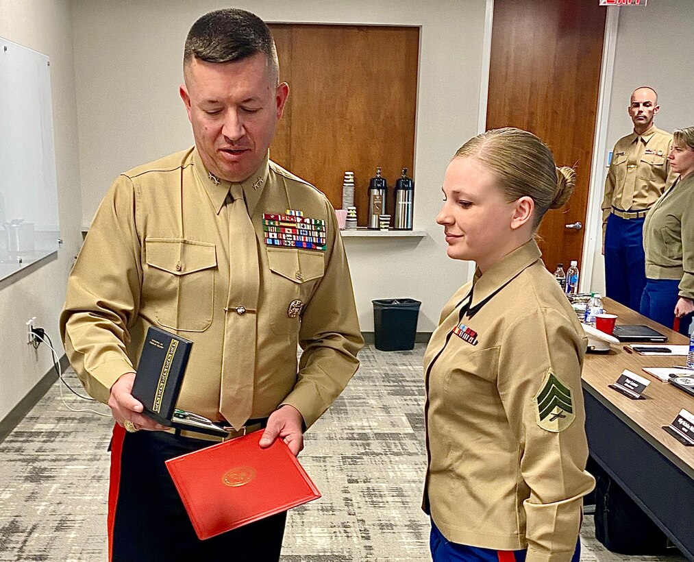 Major General James W. Bierman, Jr., commanding general of Marine Corps Recruiting Command, recognizes Sgt. Nichole Anunciacion, Marketing and Communication Marine, Recruiting Station San Francisco, 12th Marine Corps District, as the MCRC Marketing and Communication Marine of the Year during an award ceremony at Wunderman Thompson, Atlanta, Ga., February 4, 2020. Annually, MCRC selects one Recruiting Station Marketing and Communication Marine as the MAC of the year, from six Marine Corps Districts. (U.S. Marine Corps Photo by 2nd Lt. Mallory S. VanderSchans)