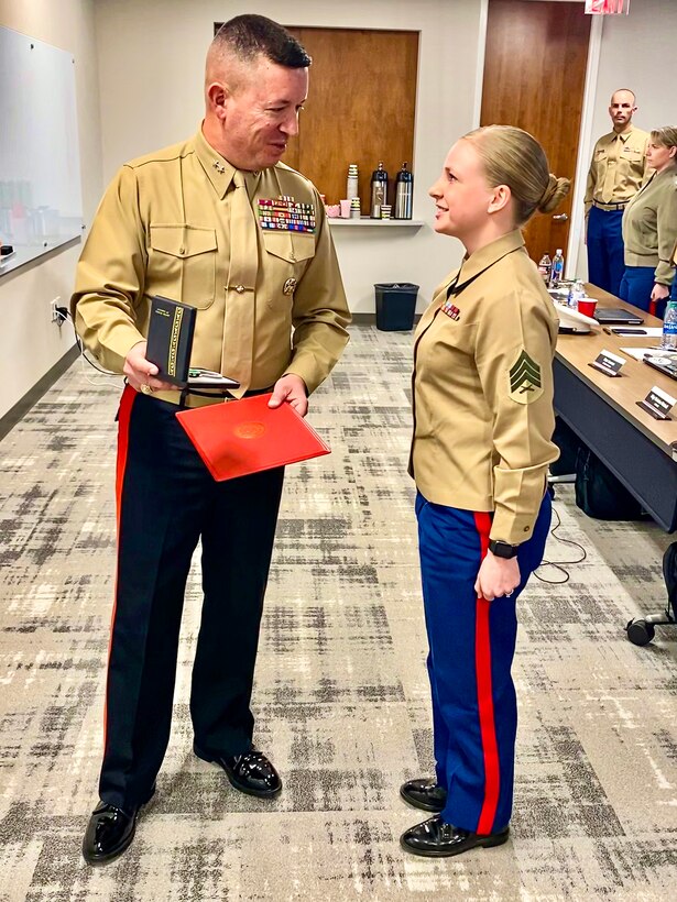 Major General James W. Bierman, Jr., commanding general of Marine Corps Recruiting Command, recognizes Sgt. Nichole Anunciacion, Marketing and Communication Marine, Recruiting Station San Francisco, 12th Marine Corps District, as the MCRC Marketing and Communication Marine of the Year during an award ceremony at Wunderman Thompson, Atlanta, Ga., February 4, 2020. Annually, MCRC selects one Recruiting Station Marketing and Communication Marine as the MAC of the year, from six Marine Corps Districts. (U.S. Marine Corps Photo by 2nd Lt. Mallory S. VanderSchans)