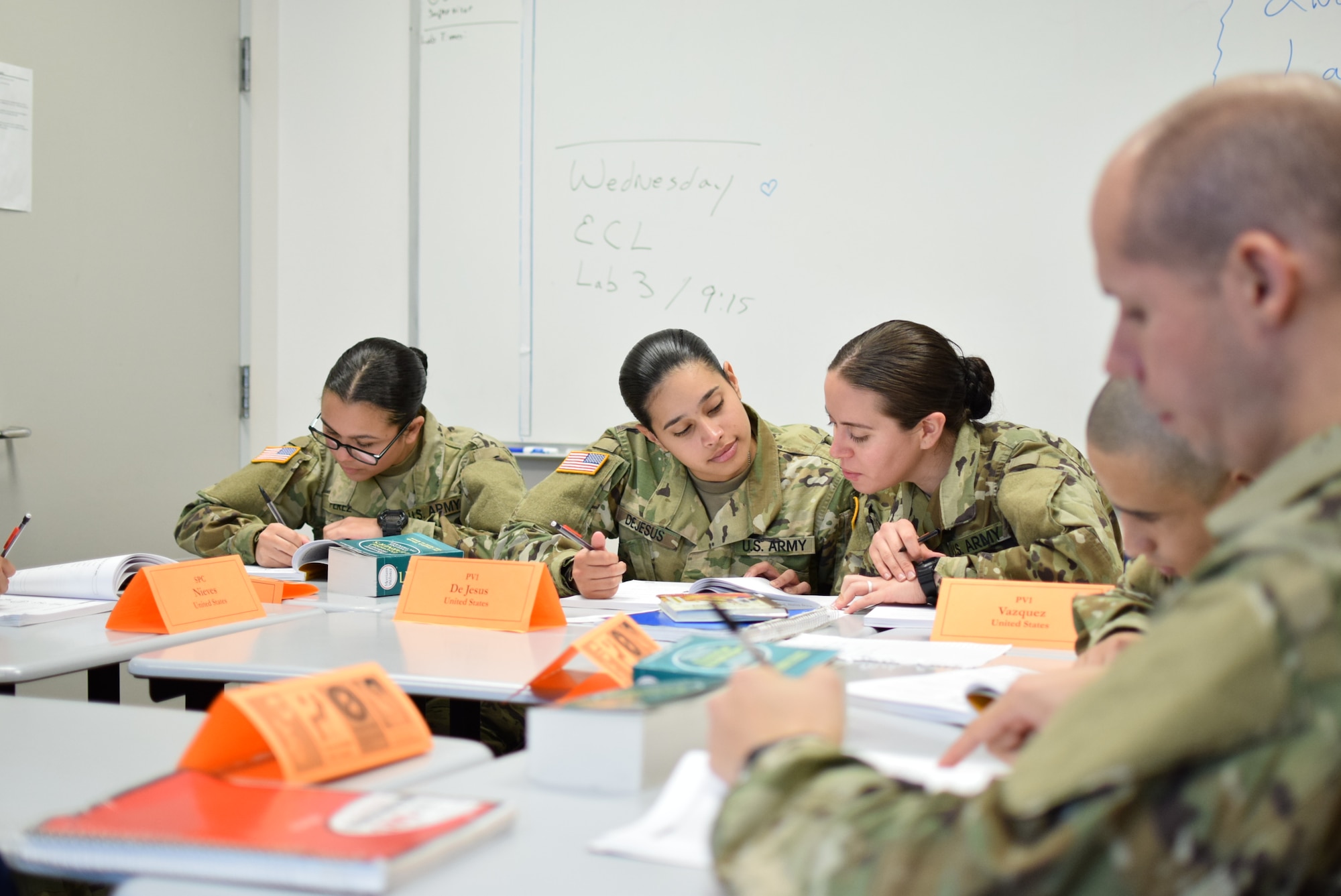 Echo Company trainees pose for a photo in a Defense Language Institute English Language Center hallway between classes. Along with English language training and pre-basic training, trainees have the opportunity to react with the 70 other unique countries on campus at one time.