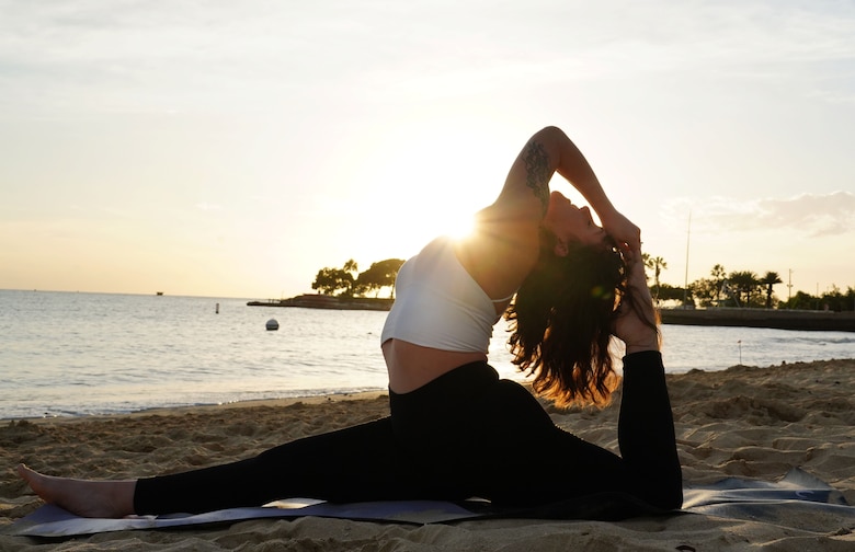 A1C Jayme Ratcliff, 324th Intelligence Squadron fusion analyst, practices yoga on Hickam Beach on Joint Base Pearl Harbor-Hickam, Hawaii, Jan. 31, 2020. Jayme has been practicing yoga for four years, and is working on her license to teach it. (U.S. Air Force photo by Airman 1st Class Erin Baxter