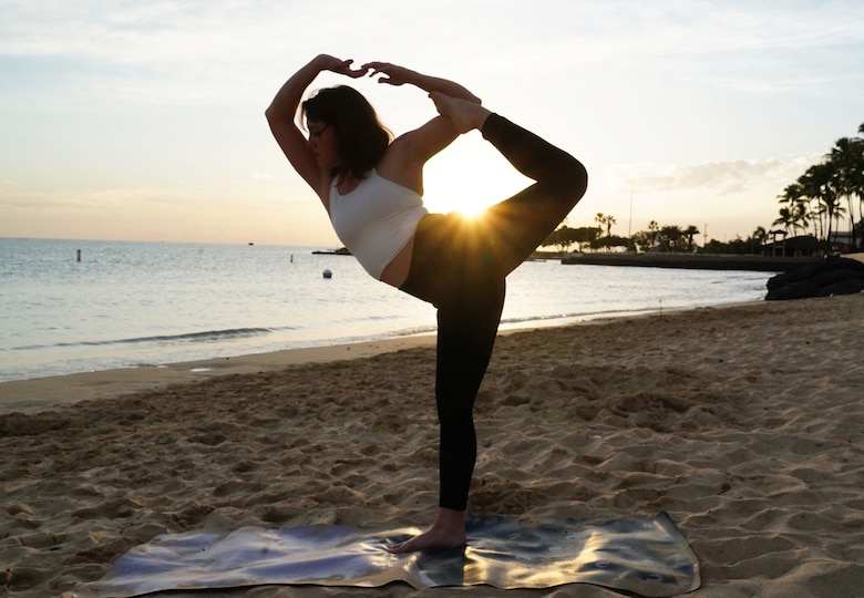 A1C Jayme Ratcliff, 324th Intelligence Squadron fusion analyst, practices yoga on Hickam Beach on Joint Base Pearl Harbor-Hickam, Hawaii, Jan. 31, 2020. Jayme has been practicing yoga for four years, and is working on her license to teach it. (U.S. Air Force photo by Airman 1st Class Erin Baxter)
