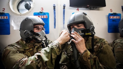 Students in training with the 359th Aerospace Medicine Squadron’s aerospace and operational physiology unit help one another don their oxygen masks Jan. 28, 2020 at Joint Base San Antonio-Randolph, Texas. The aerospace and operational physiology unit teaches aviators to prevent adverse pressure effects while airborne by eating and sleeping well, exercising, hydrating and what medications and supplements to avoid. (U.S. Air Force photo by Tech. Sgt. Katherine Spessa)