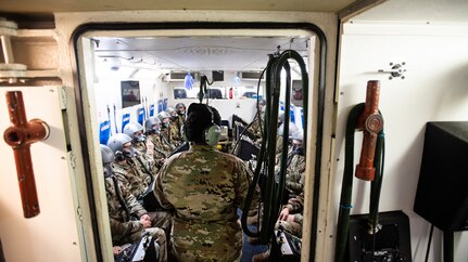 Senior Airman Deaja Ellis, 359th Aerospace Medicine Squadron aerospace and operational physiology technician, explains hypoxia symptoms during cabin decompression Jan. 28, 2020 at Joint Base San Antonio-Randolph, Texas. The hypobaric chamber simulates pressure conditions at a variety of altitudes to help aviators experience hypoxia, a lack of oxygen, so they can better identify it and respond to cabin decompression while airborne to prevent aircraft mishaps. (U.S. Air Force photo by Tech. Sgt. Katherine Spessa)