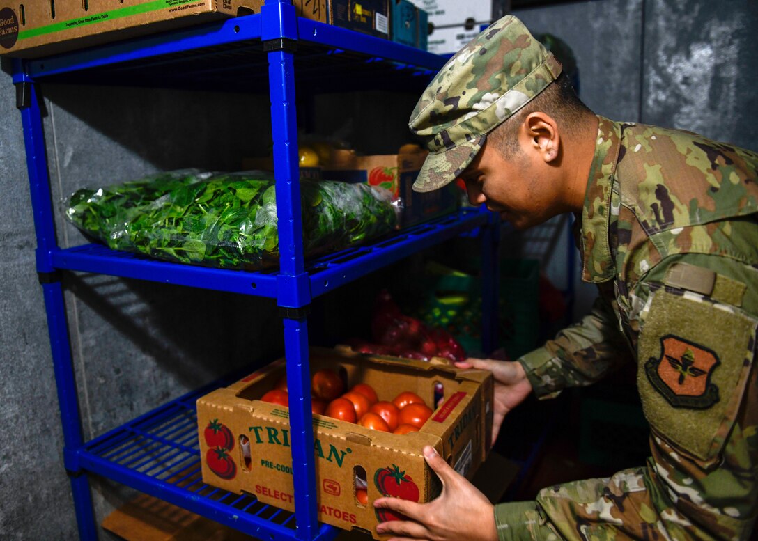 Staff Sgt. Joseph Deguino, 56th Operational Medicine Readiness Squadron Public Health communicable disease noncommissioned officer in charge, examines tomatoes during a monthly inspection Jan. 27, 2020, in Club 5/6 at Luke Air Force Base, Ariz. Every restaurant and food store on base, checking for discrepancies and ensuring that staff use mandated gear. Public health helps keep Airmen healthy, ready to train and deploy by inspecting facilities for food quality, performing audiograms and more. (U.S. Air Force photo by Airman 1st Class by Brooke Moeder)