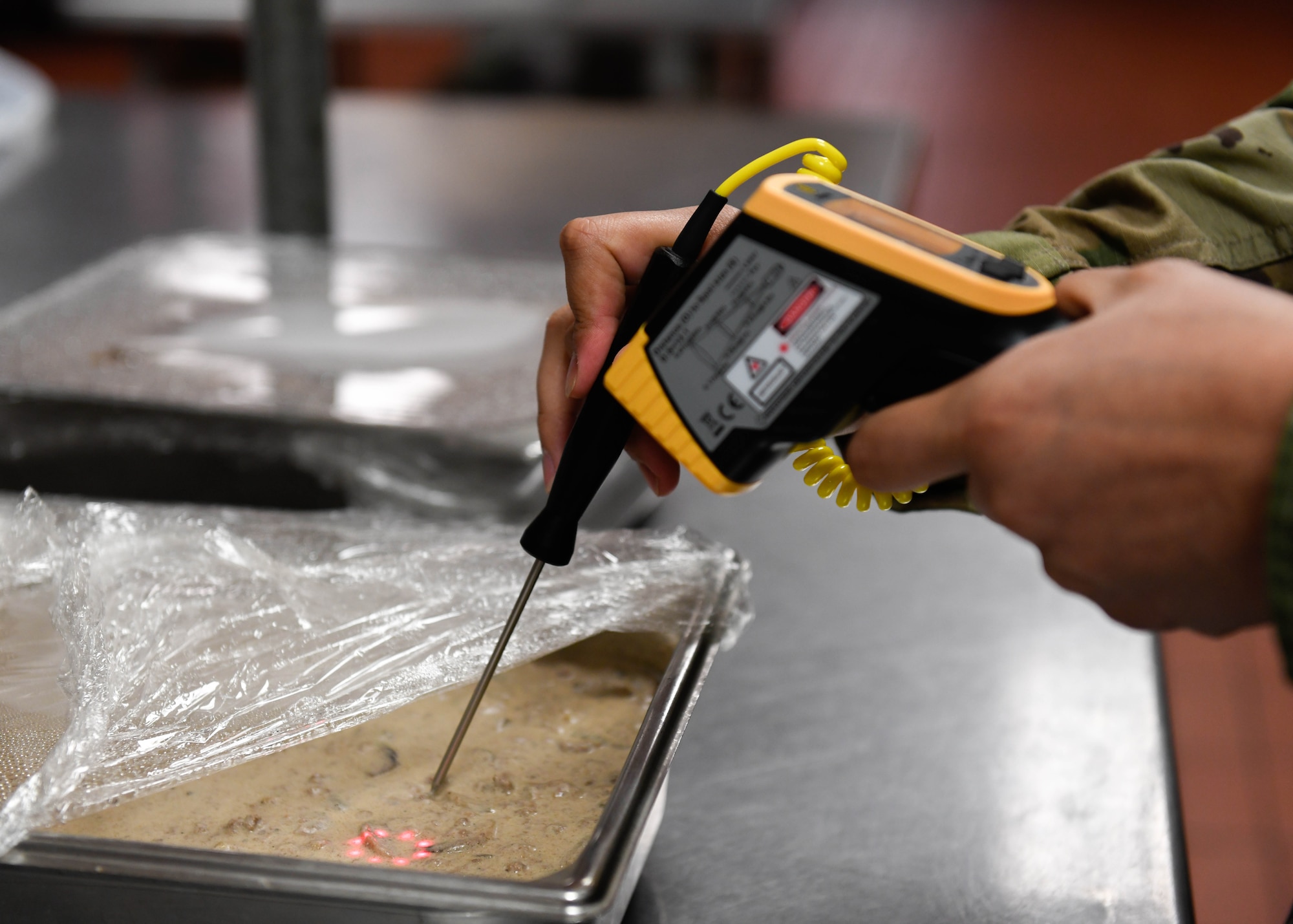 Staff Sgt. Joseph Deguino, 56th Operational Medicine Readiness Squadron Public Health communicable disease noncommissioned officer in charge, uses a thermometer to check a meal’s temperature during a monthly inspection Jan. 27, 2020, in Club 5/6 at Luke Air Force Base, Ariz. The food’s temperature has to stay between 41-135 degrees for four hours or less to keep it from spoiling. Public health helps keep Airmen healthy, ready to train and deploy by inspecting facilities for food quality, performing audiograms and more. (U.S. Air Force photo by Airman 1st Class by Brooke Moeder)