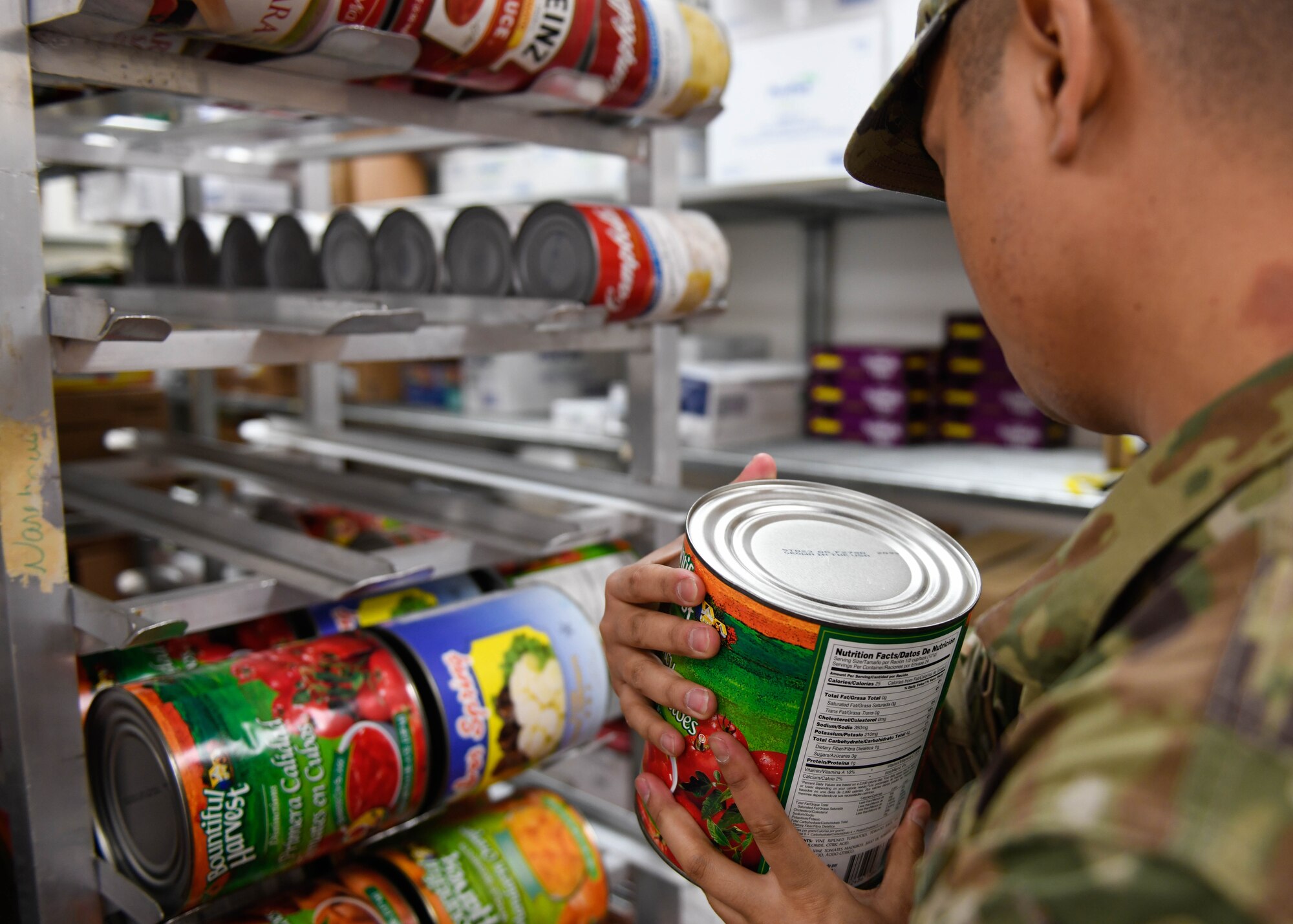 Staff Sgt. Joseph Deguino, 56th Operational Medicine Readiness Squadron Public Health communicable disease noncommissioned officer in charge, checks the expiration date on a canned good during a monthly inspection Jan. 27, 2020, in Club 5/6 at Luke Air Force Base, Ariz. While inspecting facilities, Deguino looks for expiration dates and ensures the food is properly covered. Public health helps keep Airmen healthy, ready to train and deploy by inspecting facilities for food quality, performing audiograms and more. (U.S. Air Force photo by Airman 1st Class by Brooke Moeder)