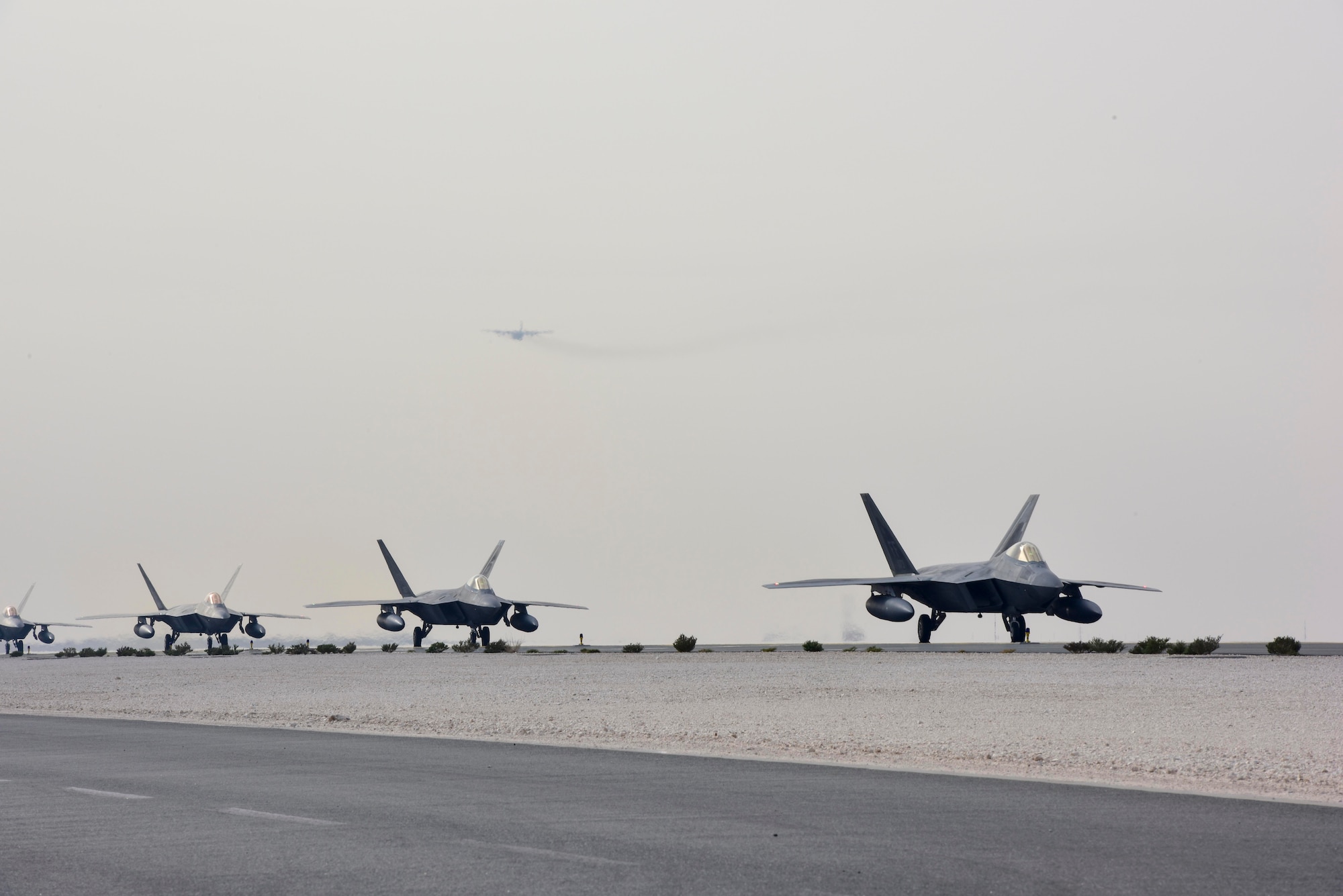 F-22 Raptors taxi to the runway at Al Udeid Air Base, Qatar on Feb. 1, 2020. The F-22 combines stealth, supercruise, maneuverability, and integrated avionics to provide air superiority throughout the U.S. Air Forces Central Command area of responsibility. (U.S. Air Force photo by Tech. Sgt. John Wilkes)