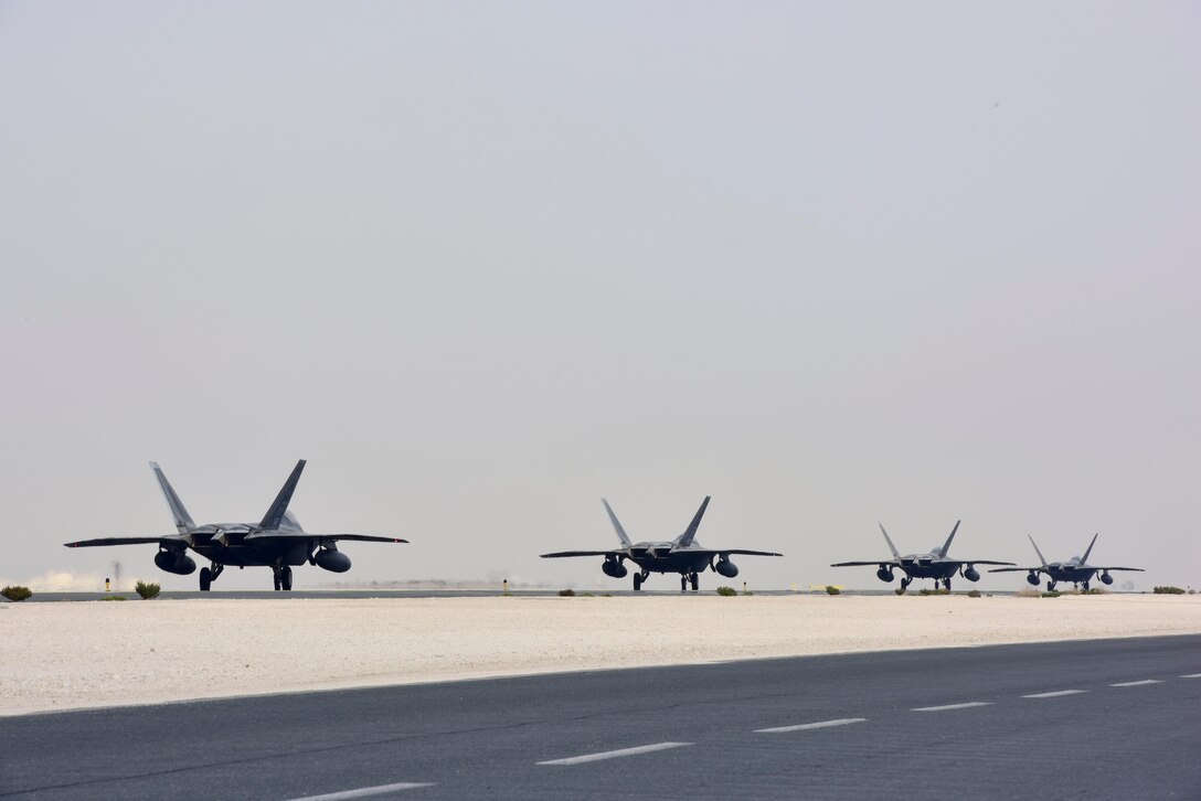 F-22 Raptors taxi to the runway at Al Udeid Air Base, Qatar on Feb. 1, 2020. The F-22 combines stealth, supercruise, maneuverability, and integrated avionics to provide air superiority throughout the U.S. Air Forces Central Command area of responsibility. (U.S. Air Force photo by Tech. Sgt. John Wilkes)