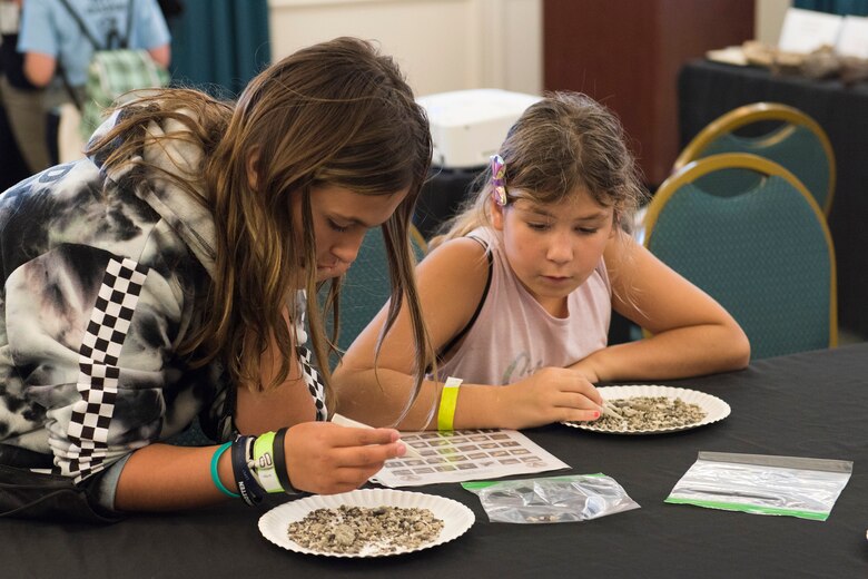 Students from Capeview Elementary School in Cape Canaveral, Fla., sift through rocks to locate actual fossils during the Women in Science and Engineering Symposium hosted by the Air Force Technical Applications Center Jan. 23, 2020. Cutline.  (U.S. Air Force photo by Matthew S. Jurgens)
