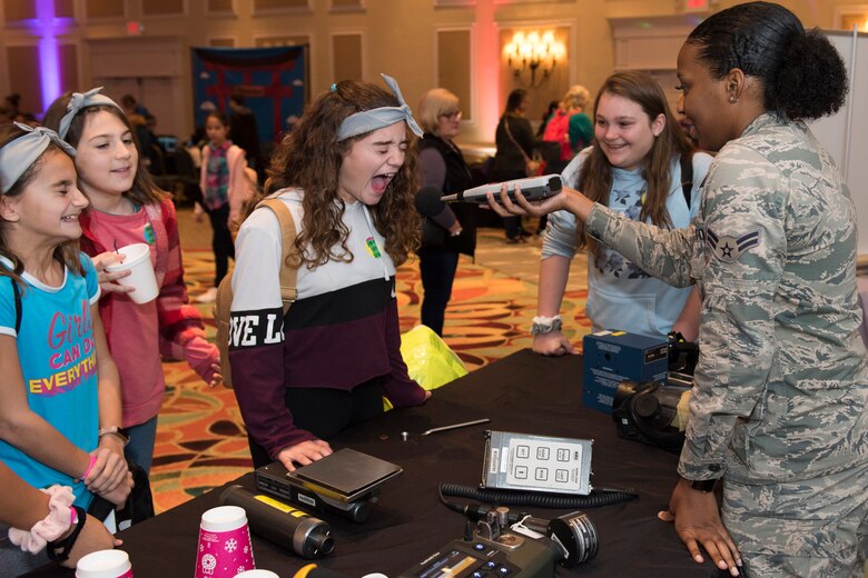 Students from Sabal Elementary School in Melbourne, Fla., participate in a yelling contest with Airman 1st Class Kishona Quinn, a member of the Air Force Technical Applications Center at Patrick AFB, Fla., using a meter that measures sound levels to test exposure to hazardous noises.  The demonstrations were part of AFTAC's annual Women in Science and Engineering Symposium Pioneer Day for local school students.  (U.S. Air Force photo by Matthew S. Jurgens)