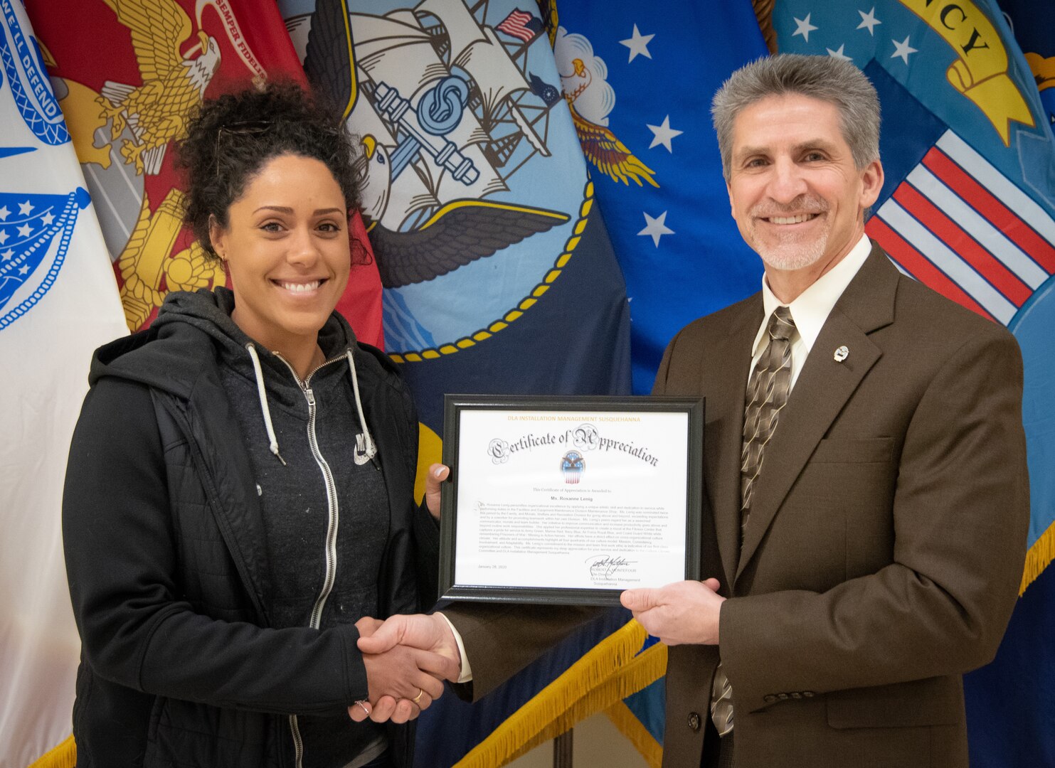 Artist receives DLA Installation Management Cultural Achievement Award for patriotic fitness center mural