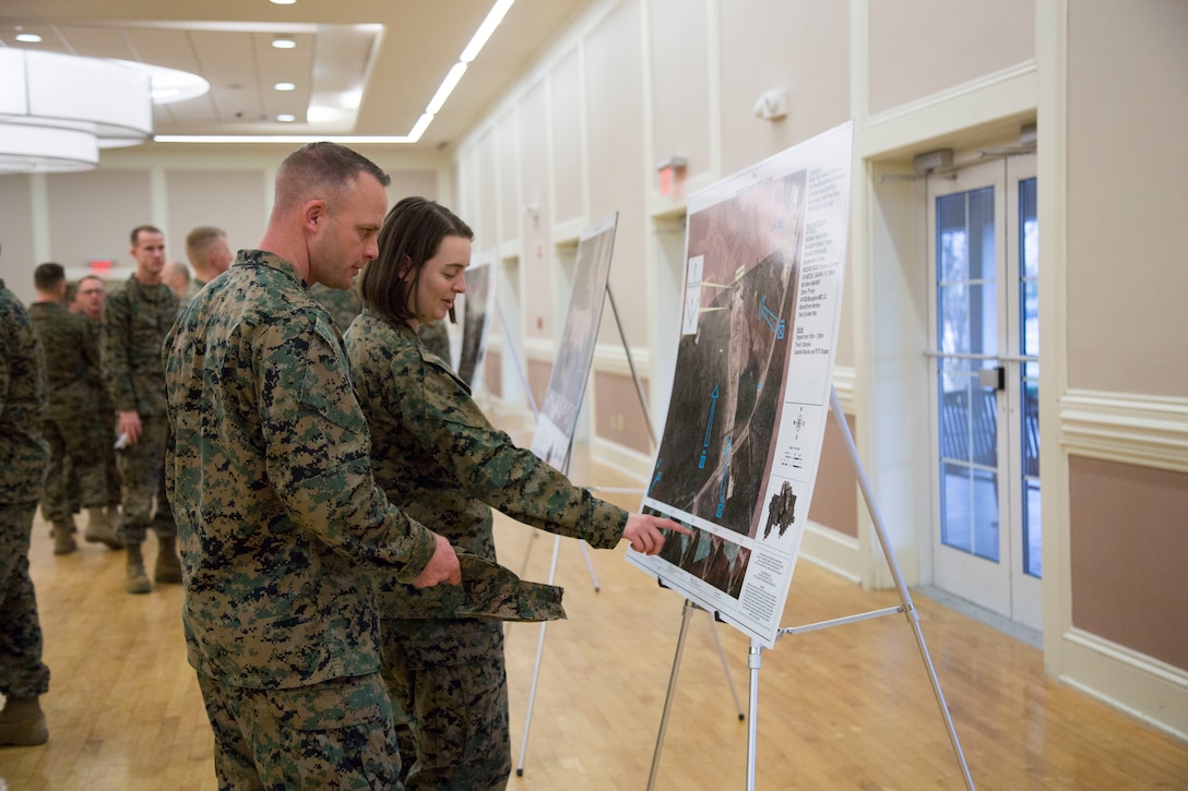 1st Lt. Ashley Velez, Headquarters and Support Company executive officer, 2nd Combat Engineer Battalion, and Gunnery Sgt. Nathaniel Gager, H&S company gunnery sergeant, 2nd CEB, have a discussion about a map displayed at the Warfighter Training Symposium at Marston Pavilion on Marine Corps Base Camp Lejeune, N.C., Jan. 24, 2020. The symposium is held annually to familiarize MCB Camp Lejeune leaders about the training capabilities on the more than 120,000 acres of range training areas. (U.S. Marine Corps photo by Cpl. Dominique Osthoff)