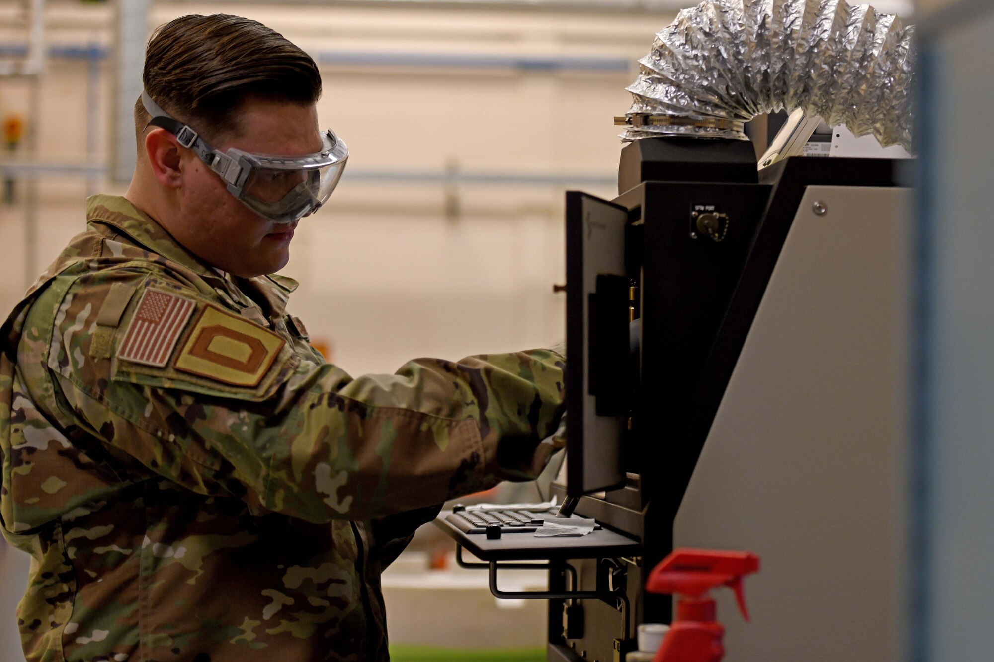 Airman 1st Class Alexander Dixon, 100th Maintenance Squadron non-destructive inspection journeyman, places a sample inside a spectrometer at RAF Mildenhall, England, Jan. 23, 2020. The joint oil analysis program allows non-destructive inspection Airmen to check for failures of aircraft engines through discrepancies in oil. (U.S. Air Force photo by Staff Sgt. Lexie West)