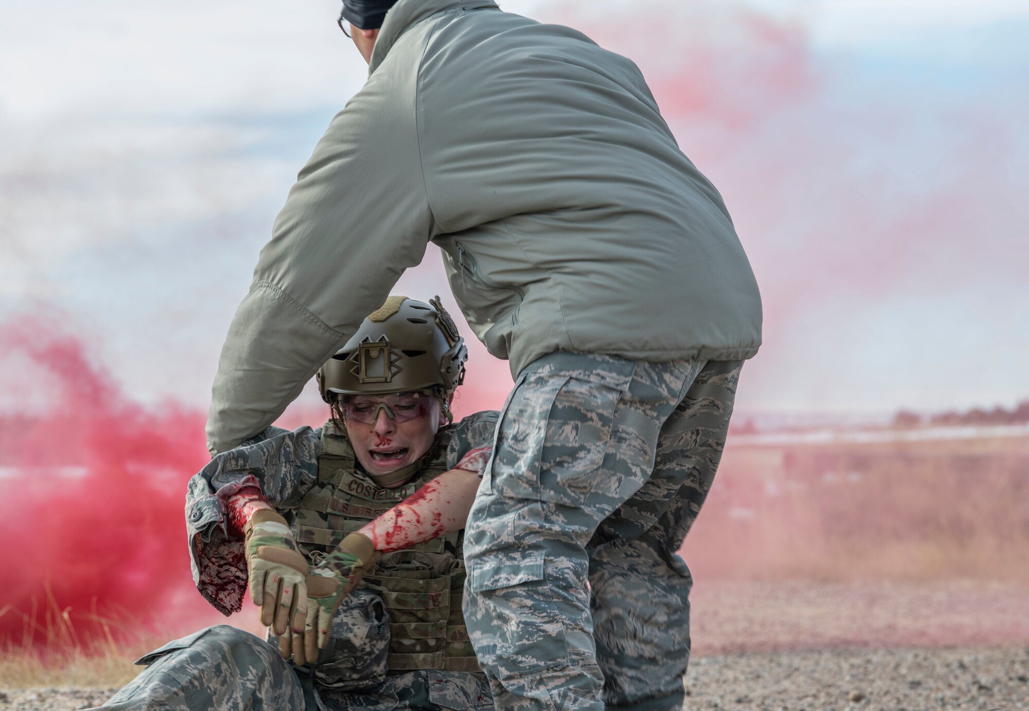 An Airman, reprresenting the injured, has been pulled out of a buring humvee and is placed away from danger for assessment during a 90th Civil Engineer Squadron Explosive Ordinance Disposal flight Self Aid Buddy Care training Jan. 16, 2020. The one-day training allowed Airmen from the 90th Mission Support Group to enhance their knowledge on Self Aid Buddy Care, in a combat environment, including treatment for a collapsed lung. (U.S. Air Force photo by Senior Airman Abbigayle Williams)