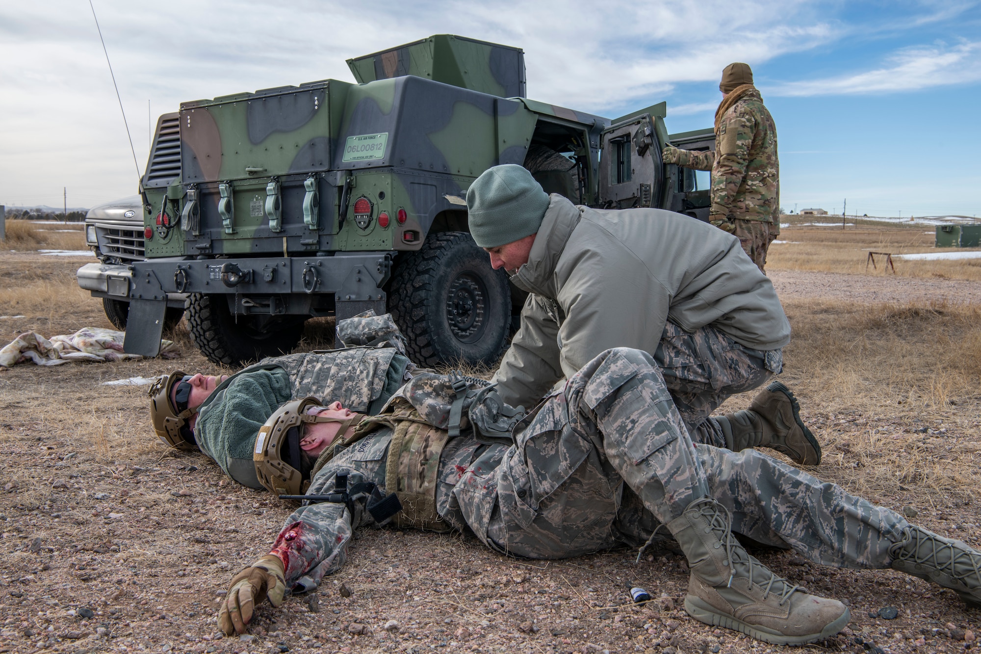 Airmen, representing the injured, have their injuries assessed during a Self Aid Buddy Care training provided by 90th Civil Engineer Squadron Explosive Ordinance Disposal flight Jan. 16, 2020, at F.E. Warren Air Force Base, Wyo. The routine training added an element of combat scenarios, allowing 90th Mission Support Group Airmen to practice SABC in a unique and potentially life threatening situation. (U.S. Air Force photo by Senior Airman Abbigayle Williams)