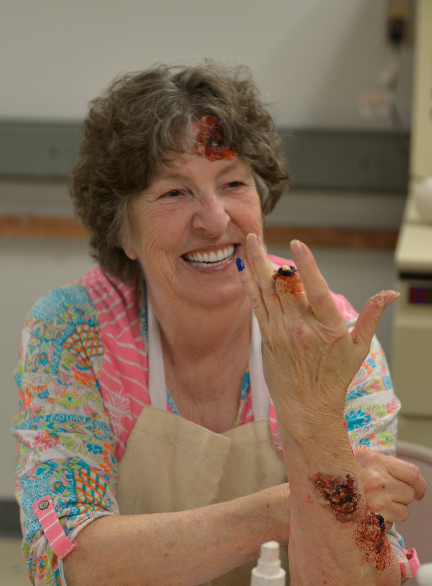 Lemara Mays, moulage training volunteer, presents her simulated injury during moulage training inside Wolfe Hall at Keesler Air Force Base, Mississippi, Jan. 29, 2020. Moulage, also known as combat injury simulation, is used in base exercises to simulate the outcome of various situations such as chemical burns, piercing wounds and missing limbs using different tools such as latex, stage blood, sponges and makeup products. (U.S. Air Force photo by Airman 1st Class Kimberly Mueller)