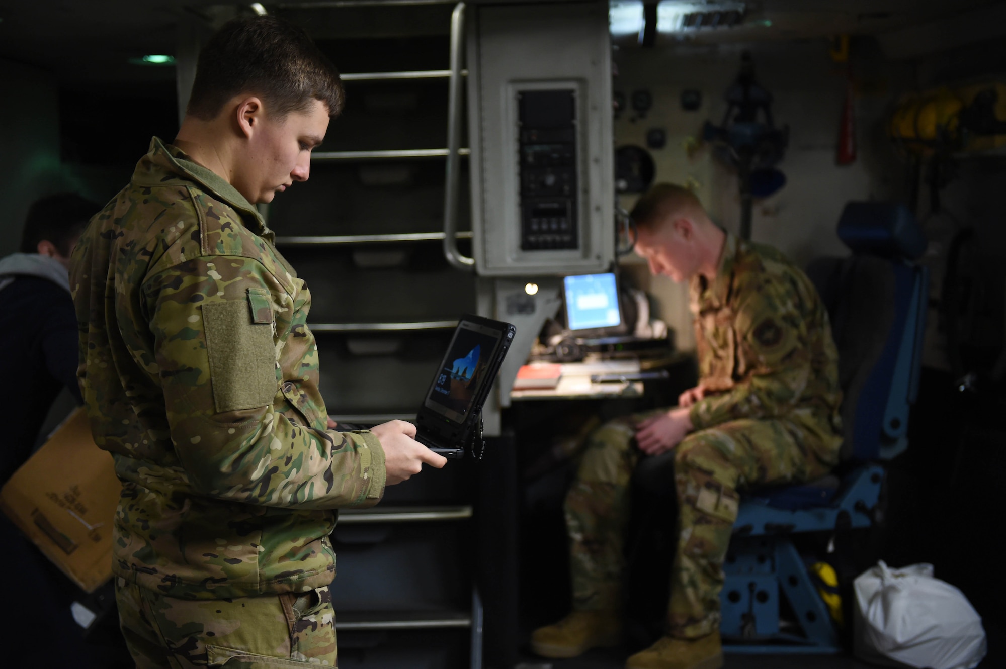 Airman 1st Classes Ryan Nelson and Kam Watt, 4th Airlift Squadron loadmasters, complete their pre-flight checklists aboard a C-17 Globemaster III before taking off from Spangdahlem Air Base, Germany, Dec. 18, 2019. The loadmaster pre-flight checklist includes things like making sure the oxygen masks are functional and that any cargo is safely secured. (U.S. Air Force photo by Airman 1st Class Mikayla Heineck)